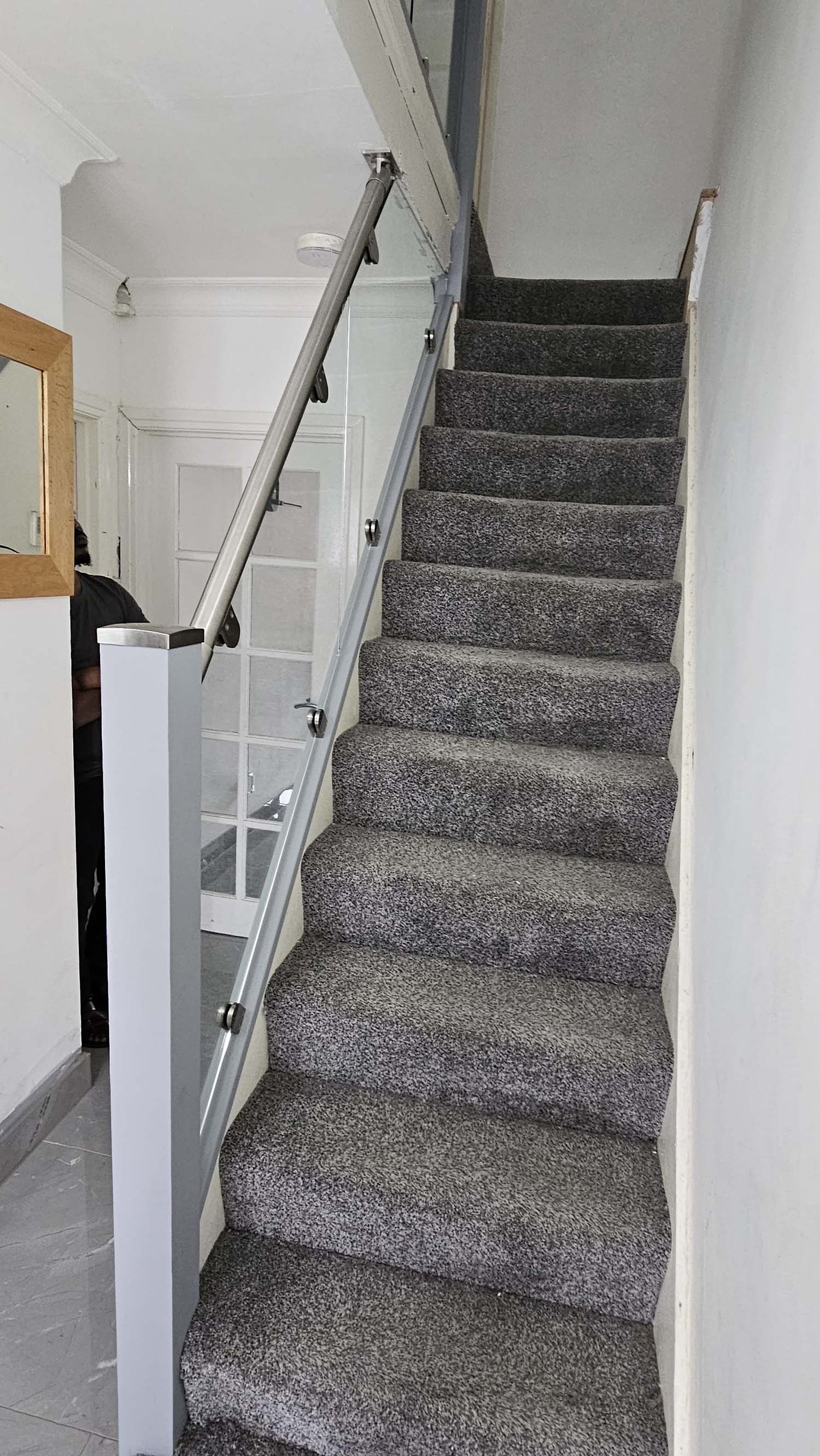 clamped glass balustrade with stainless steel bannister