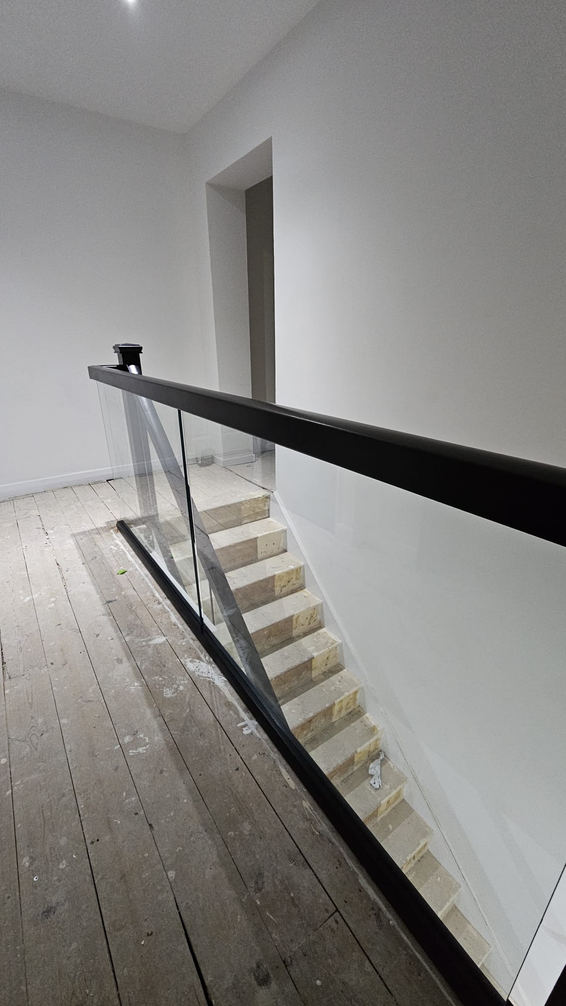 black landing bannister with embedded glass balustrade